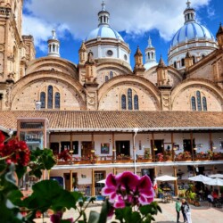 The iconic blue domes of Cuenca's New Cathedral stand out against the cityscape, a must-see architectural marvel in the heart of the city.