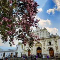 The famed yellow and white municipal building of Antigua with arches, a cornerstone for history enthusiasts on an Antigua, Guatemala itinerary.