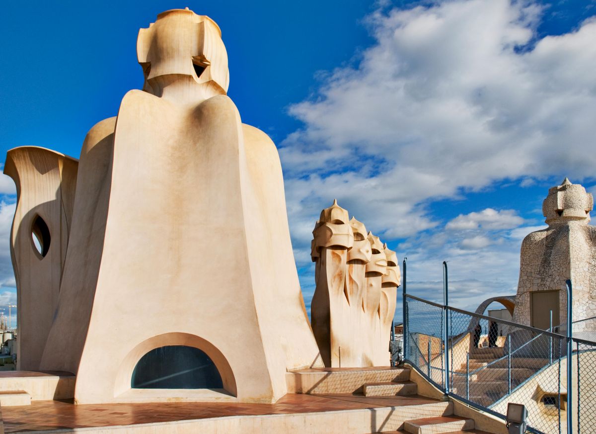 The unique chimneys and undulating architecture of Casa Milà's rooftop against a blue sky, a testament to Gaudí's modernist vision, and a highlight on any Barcelona itinerary.