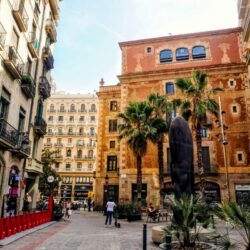 A tranquil street corner in Barcelona's Gothic Quarter, where historical architecture meets contemporary urban life, a cultural fusion to explore on a Barcelona itinerary.